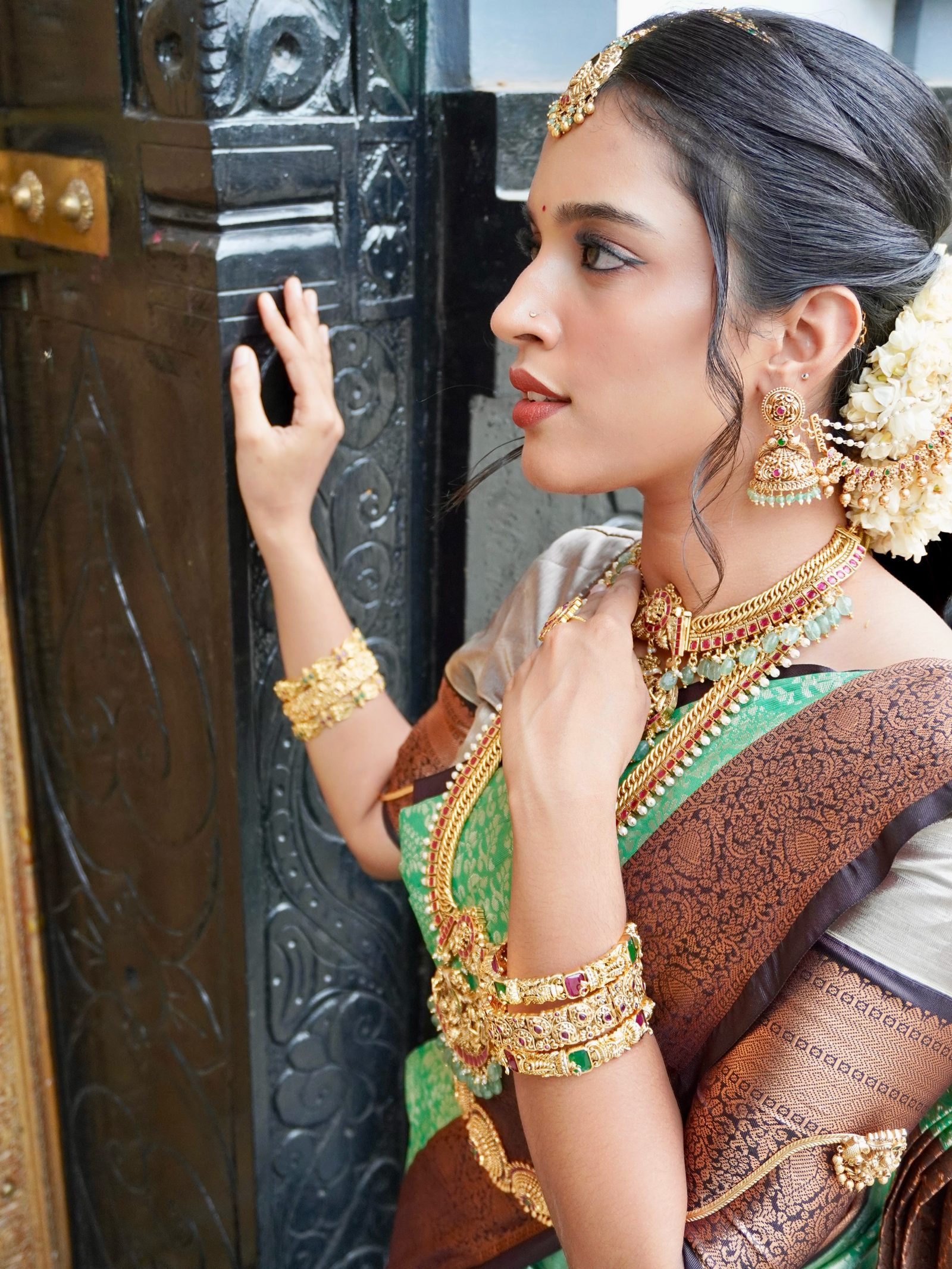 Aiswarya looking down with palakka mala draping