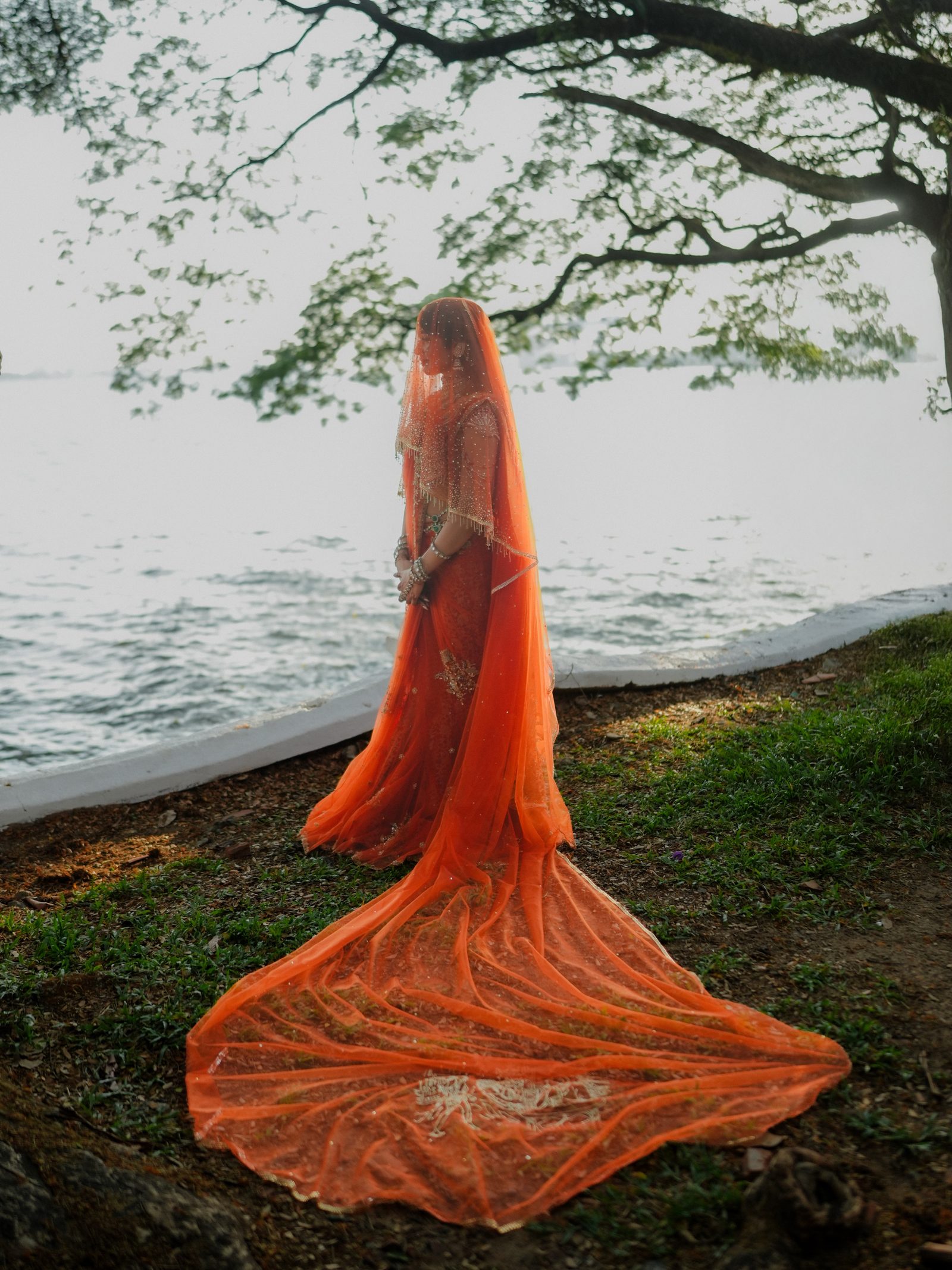 Reshma in a wide outdoor portrait by water