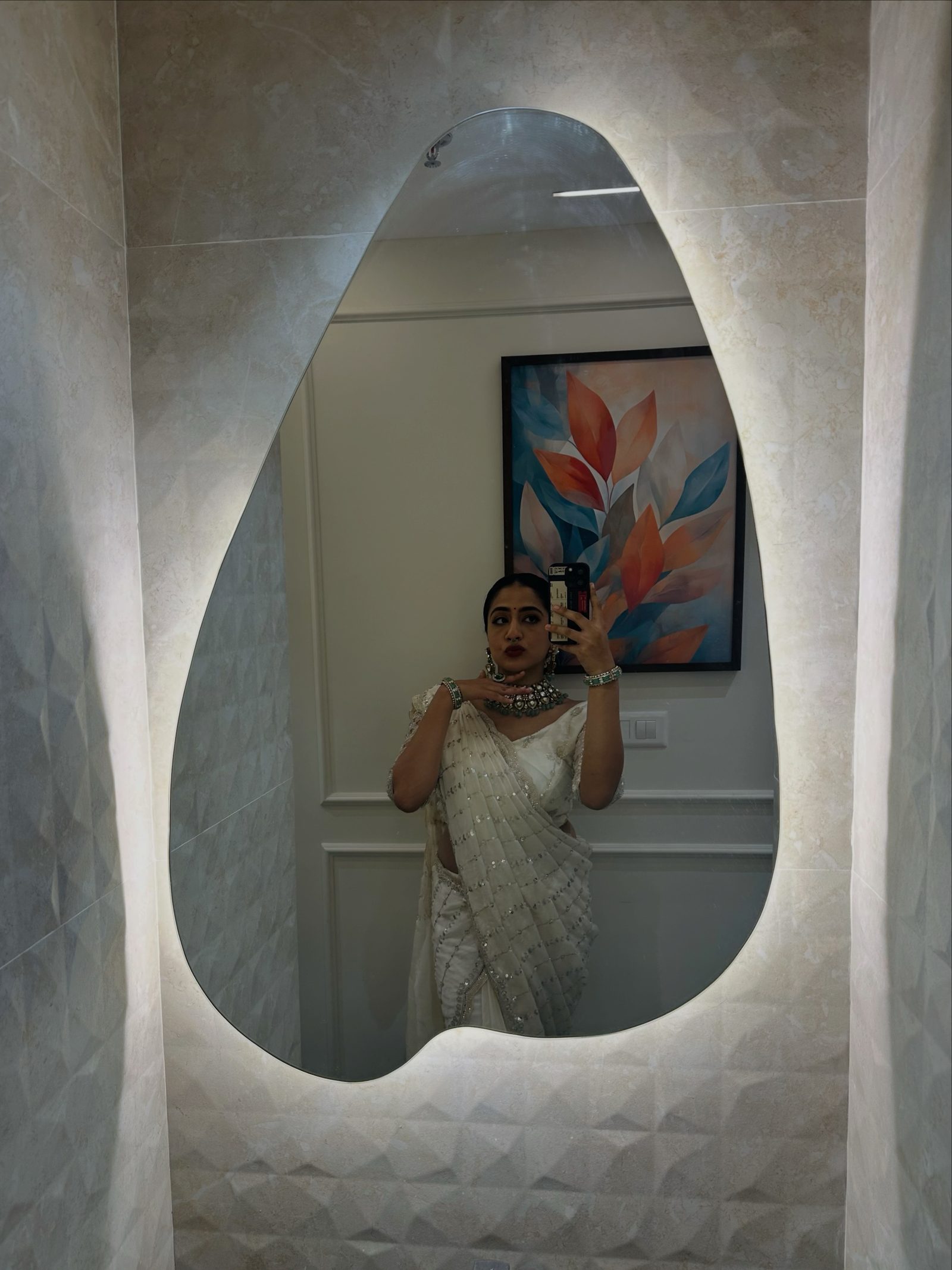 A bride in front of the Golden Cup Calicut showroom mirror