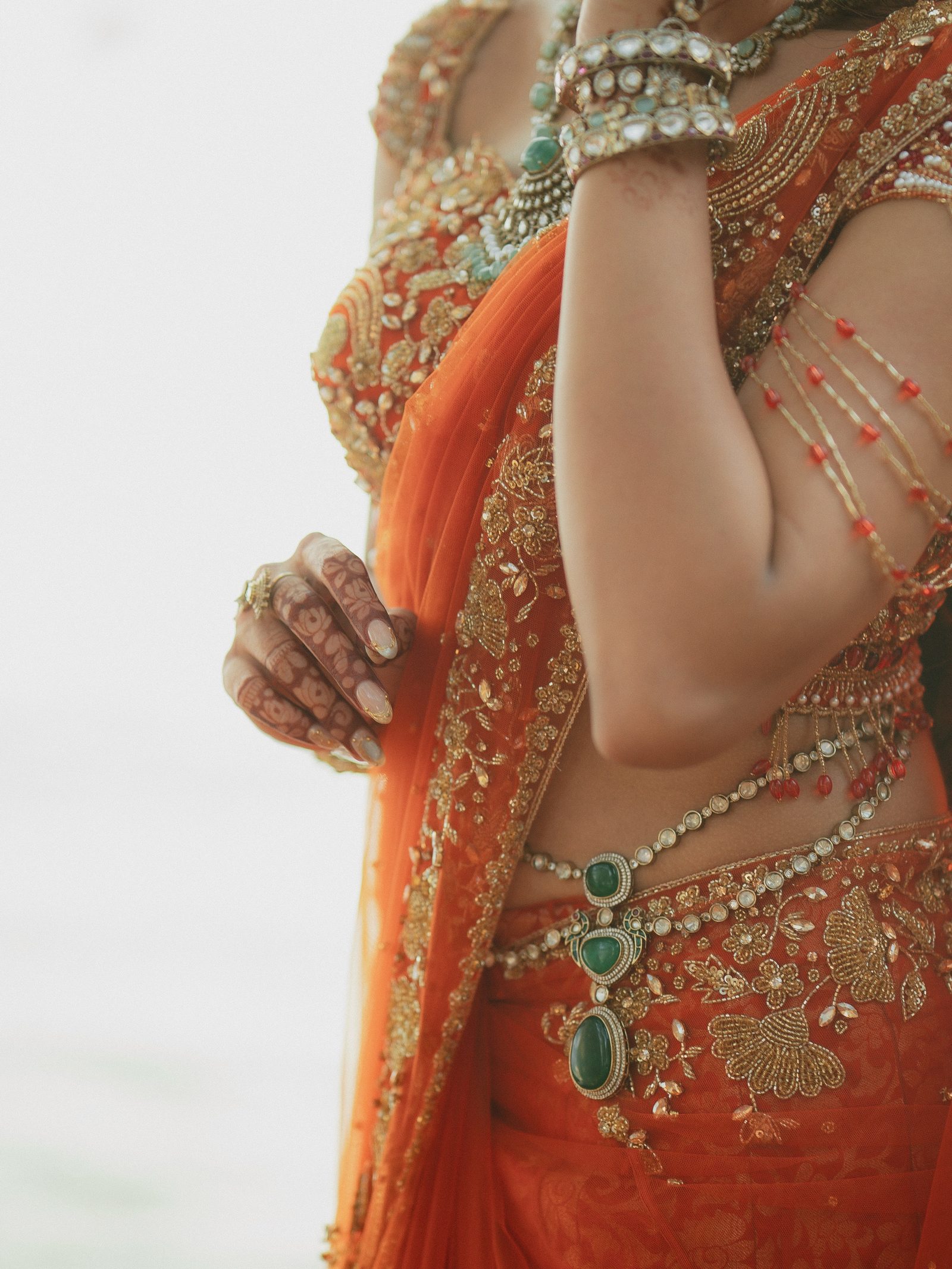 Detail of Reshma's waist chain and henna hand